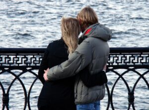 couple cuddling by sea